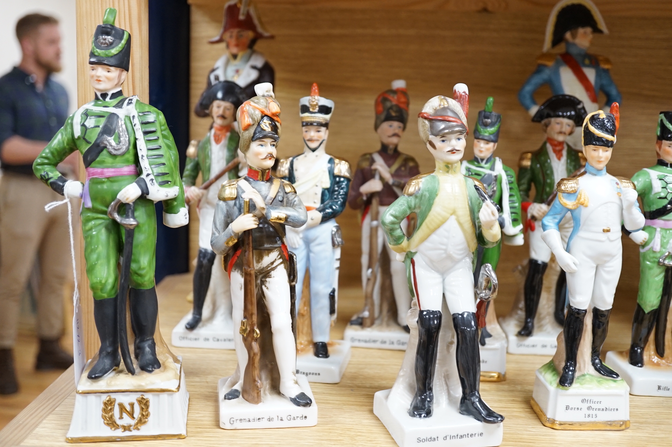 Twenty porcelain figures of soldiers including Officer Light Dragoon and Rifle Brigade, largest 31cm high